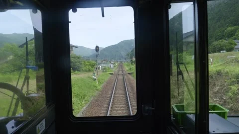 Frontal cabin view of train passing through rural countryside in Japan Stock Footage 342287407