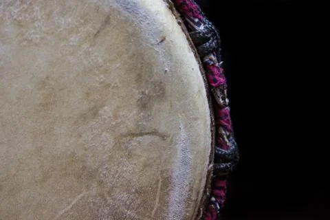 Frontal Close-Up of a sinlge West African Drum in Dramatic Single Light. Stock Photos