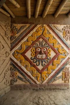 Frontal close up of a vibrant polychrome adobe relief mural depicting the Moche Stock Photos