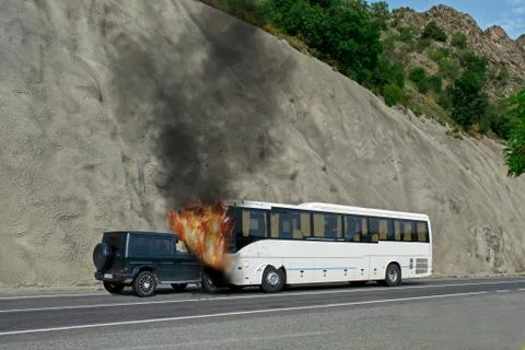 Frontal collision between a bus and a car. Accident followed by fire. Stock Photos