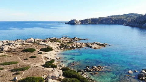 Frontal flight to flight over a small beach with transparent water side on t Stock Footage 128842275