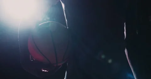 Frontal key shot of basketball player holding ball on hip Stock Footage