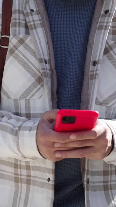 Frontal shot of unrecognizable young man walking in city park using cell phone Stock Footage 275167591
