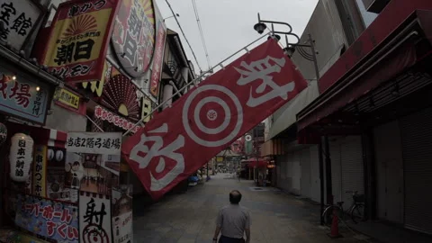 Frontal Traveling of Man Walking Down Shinsekai Street in Osaka Japan Vídeos de archivo 336583072