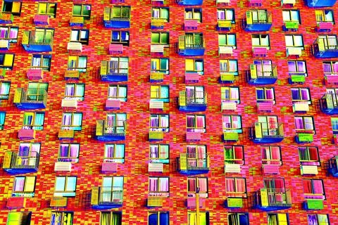 Frontal view of the facade of the building with many windows. Changed color s Ilustración de archivo