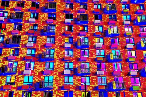 Frontal view of the facade of the building with many windows. Changed color s Ilustración de archivo