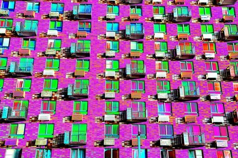 Frontal view of the facade of the building with many windows. Changed color s Ilustración de archivo