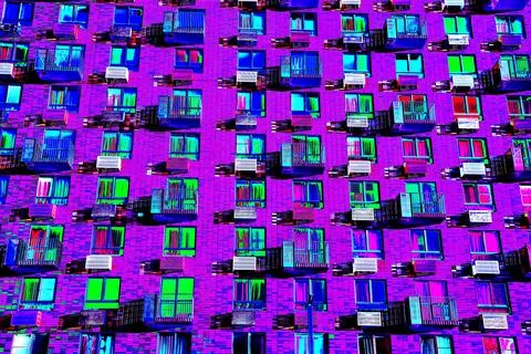 Frontal view of the facade of the building with many windows. Changed color s Ilustración de archivo