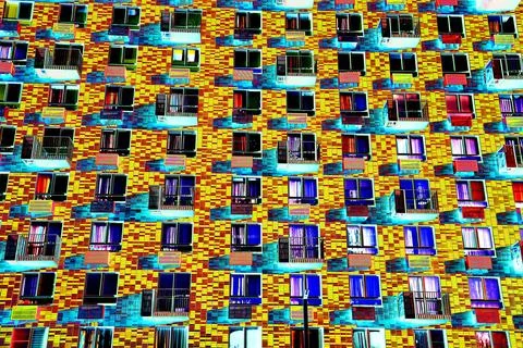 Frontal view of the facade of the building with many windows. Changed color s Ilustración de archivo