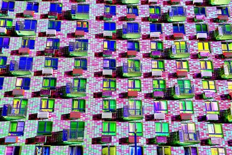 Frontal view of the facade of the building with many windows. Changed color s Ilustración de archivo