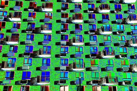 Frontal view of the facade of the building with many windows. Changed color s Ilustración de archivo