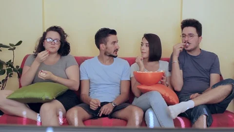 Frontal view on group of friends having good time while watching TV Stock Footage 93874282