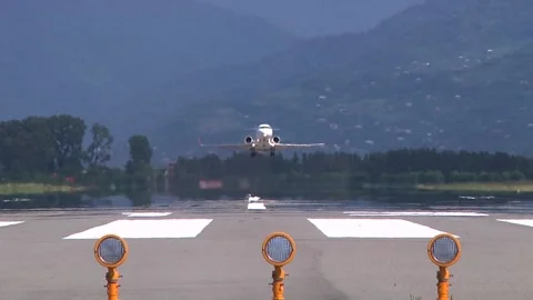 Frontal view of a jet airplane taking off from an airport on a sunny day. Stock Footage 139360788