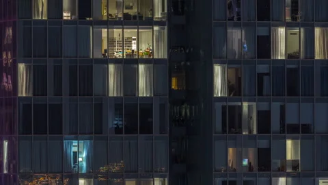 Frontal view of night facade of building with a lot of windows with light Stock Footage 264838330