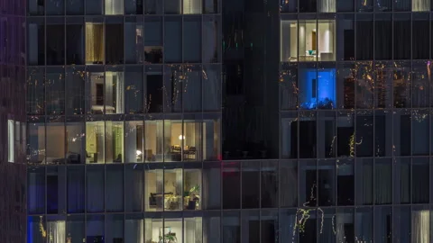 Frontal view of night facade of building with a lot of windows with light Stock Footage 264839097