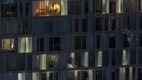 Frontal view of night facade of building with a lot of windows with light Stock Footage 271353423