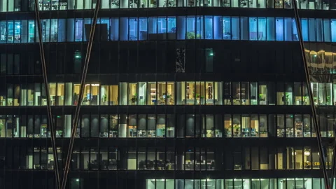 Frontal view of night facade of building with a lot of windows with light Stock Footage 274193935