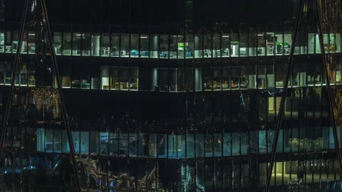 Frontal view of night facade of building with a lot of windows with light Stock Footage 314376036