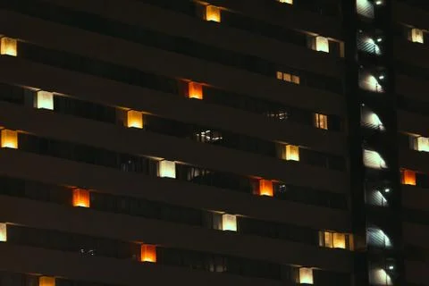Frontal view of the night facade of building with a many windows Foto stock