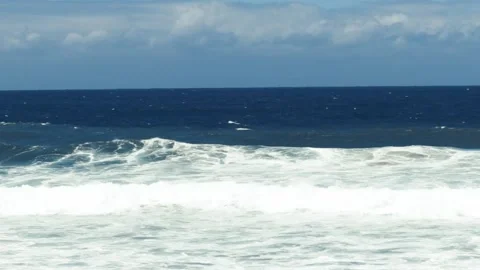 Frontal view of ocean waves crashing down a beach, with white surf Stock Footage 145067377