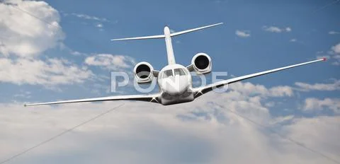 Frontal view of a private jet in midair Stock Photos