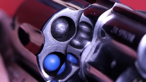 Frontal view of revolver from chambers panning to muzzle close up shallow focus 動画素材 114417469