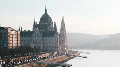 Frontal view of slow moving traffic passing by the Iconic Hungarian Parliament Stock-Footage 330914747