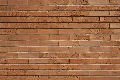 Frontal View of Thin Orange Brick Wall Foto stock