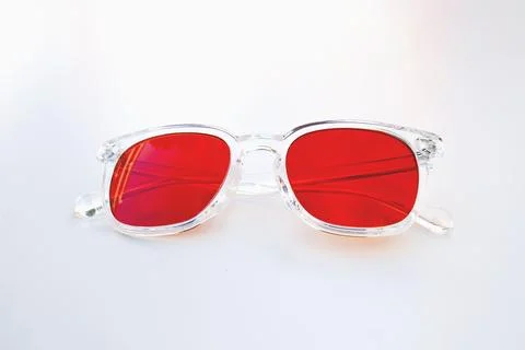 Frontal view of transparent frame red lens glasses designed for night use to  Stock Photos