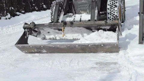 Frontal View of Wide Loader Blade Clearing Snowy Driveway Stock Footage 347884863