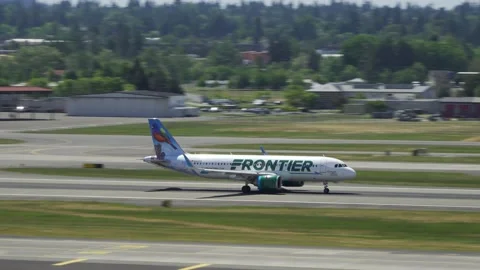 Frontier Airlines rolling down the runway at Portland Airport. Portland, OR USA Stock Footage 200929247