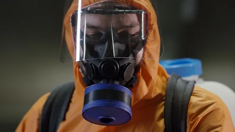 Frontline Coronavirus Worker in Full Hazmat Suit Spraying Disinfectant on Stock-Footage 129264673