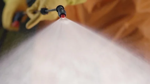 Frontline Coronavirus Worker in Full Hazmat Suit Spraying Disinfectant on Stock-Footage 129267359