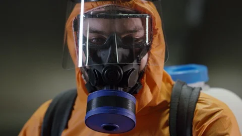 Frontline Coronavirus Worker in Full Hazmat Suit Spraying Disinfectant on Stock-Footage 129269258