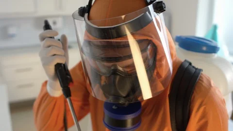 Frontline Coronavirus Worker in Hazmat Suit Disinfecting Operating Theater from Stock Footage 129100321