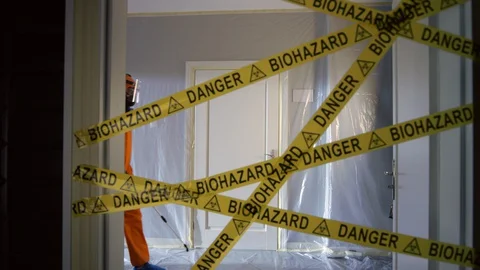 Frontline Worker in Full Hazmat Suit Enters Coronavirus Contaminated Room Stock Footage 129188896