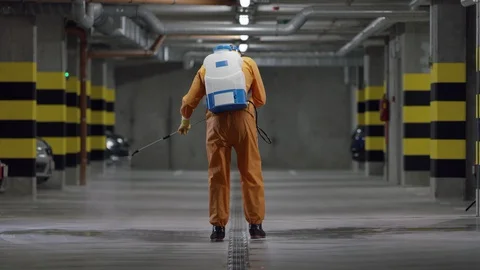 Frontline Worker in Full Hazmat Suit Disinfects Coronavirus Contaminated Car Stock Footage 129188980