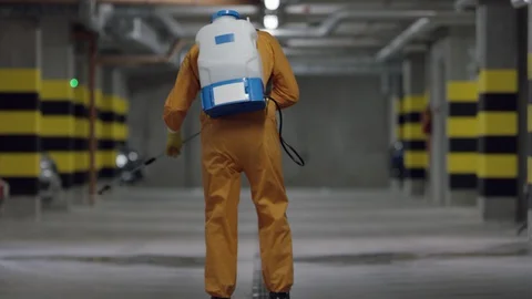 Frontline Worker in Full Hazmat Suit Disinfects Coronavirus Contaminated Car Stock-Footage 129189244