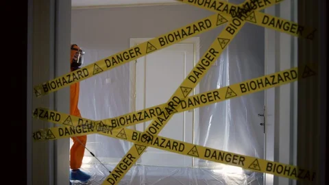 Frontline Worker in Full Hazmat Suit Enters Coronavirus Contaminated Room Stock Footage 129191911