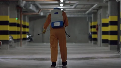 Frontline Worker in Full Hazmat Suit Disinfects Coronavirus Contaminated Car Stock Footage 129192042