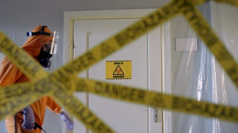 Frontline Worker in Full Hazmat Suit Enters Coronavirus Contaminated Room Stock Footage 129192356