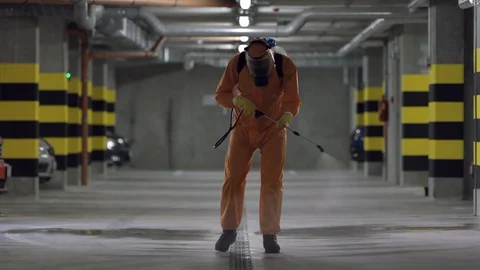 Frontline Worker in Full Hazmat Suit Disinfects Coronavirus Contaminated Car Stock Footage 129192802