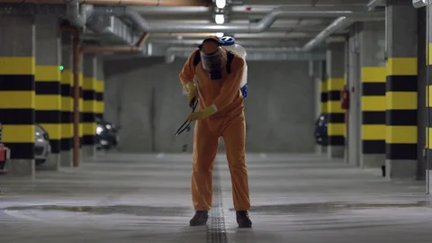Frontline Worker in Full Hazmat Suit Disinfects Coronavirus Contaminated Car Stock Footage 129192939