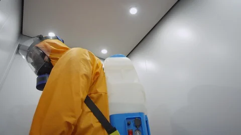 Frontline Worker in Full Hazmat Suit Standing in Elevator Stock Footage 129193048