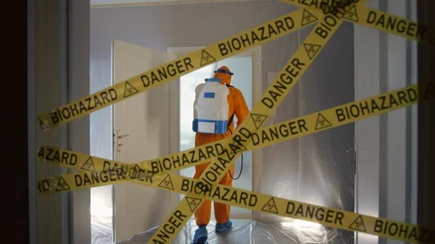 Frontline Worker in Full Hazmat Suit Enters Coronavirus Contaminated Room Stock Footage 129193199