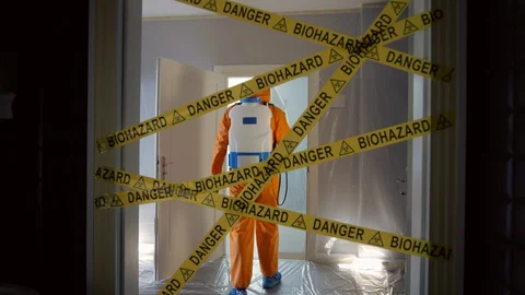 Frontline Worker in Full Hazmat Suit Enters Coronavirus Contaminated Room Stock-Footage 129193307