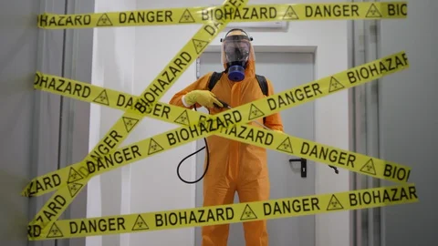 Frontline Worker in Full Hazmat Suit Standing in Coronavirus Contaminated Stock Footage 129194017