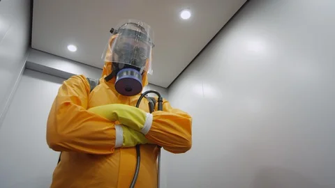 Frontline Worker in Full Hazmat Suit Standing in Elevator Stock Footage 129194869