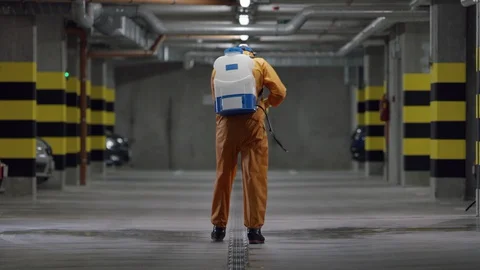 Frontline Worker in Full Hazmat Suit Disinfects Coronavirus Contaminated Car Stock Footage 129198437