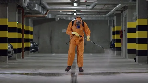 Frontline Worker in Full Hazmat Suit Disinfects Coronavirus Contaminated Car Stock Footage 129199110
